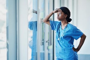 Female doctor or nurse looking stressed at work